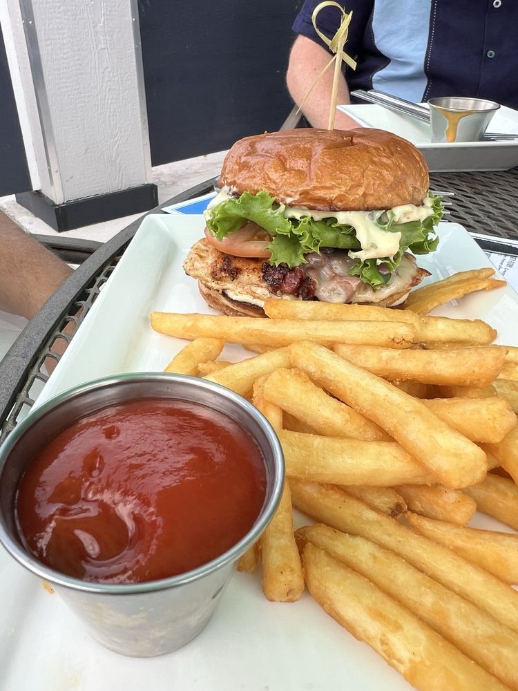 Grilled chicken club sandwich with fries and ketchup